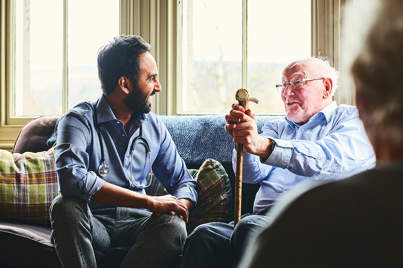 men talking on couch