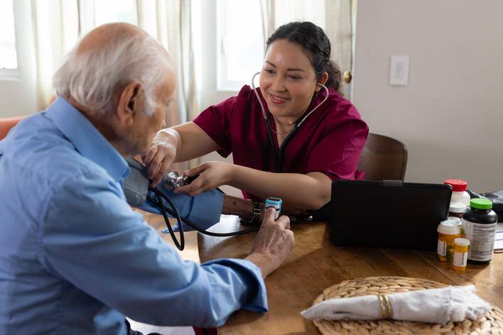 Clinician checking the blood pressure of a member