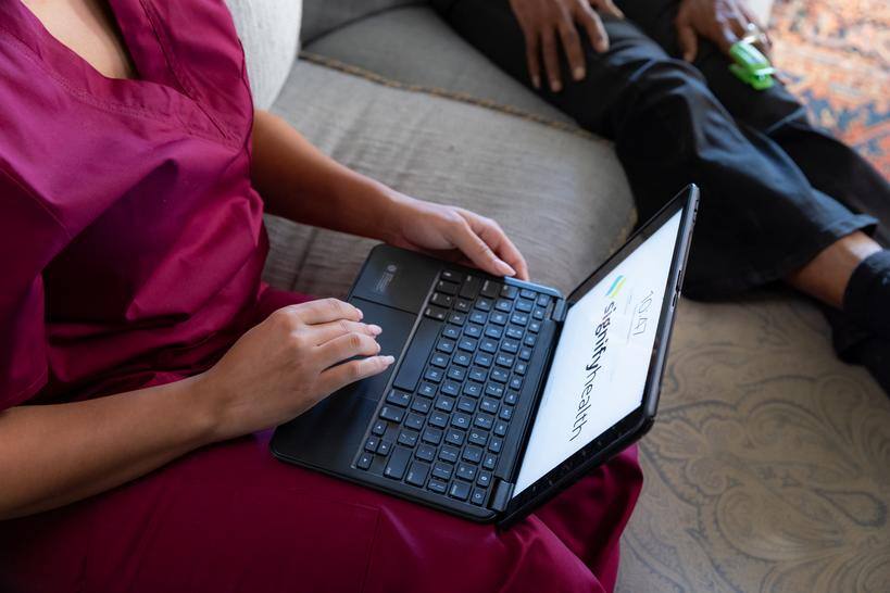 A clinician working on a computer